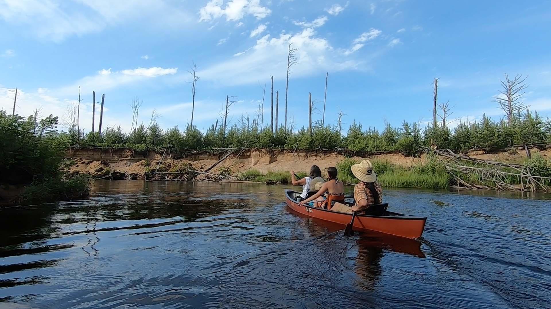 Three people canoeing the Two Hearted River.